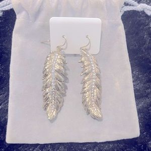 Gold leaf earrings with rein stones down the middle.